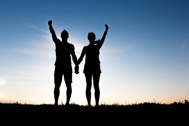 istock silhouette of romantic lovers with sunset on the back 849897828