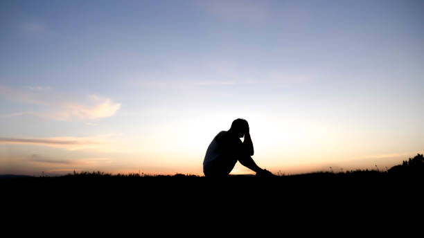 istock Sad young man silhouette worried at sunset 849900868