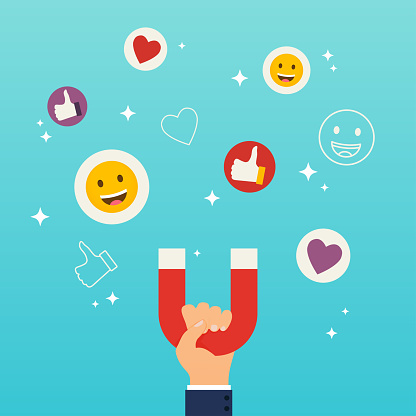 istock Social media marketing concept. Hand holding magnet attracting likes, hearts and reaction smileys. 849901558