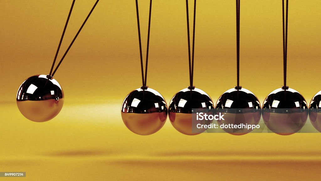 cause and effect concept, metal Newton's cradle on a white background close up of a Newton's cradle Newton's Cradle Stock Photo