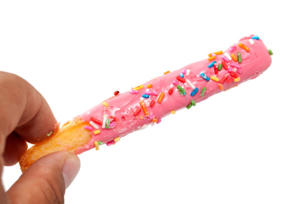 istock hand holding colorful doughnut Stick isolated on white background 849912186