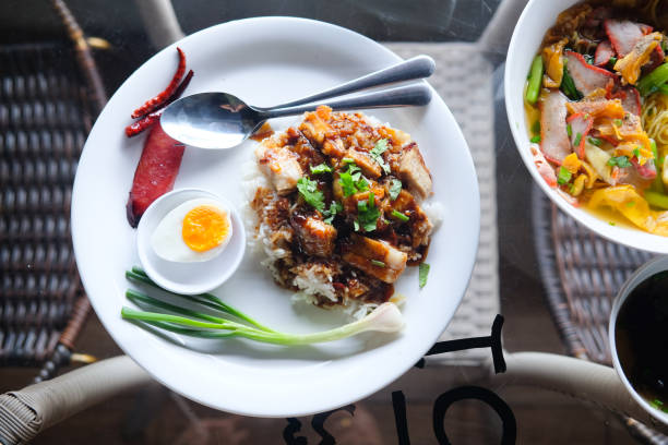istock Crispy pork and rice in white dish on glass table 849916116