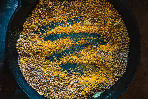 istock Cooking masala for curry on dark background top view 849916186