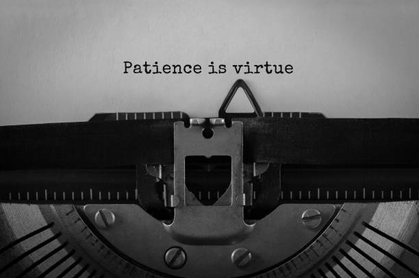 Text Patience is virtue typed on retro typewriter Text Patience is virtue typed on retro typewriter innocence stock pictures, royalty-free photos & images