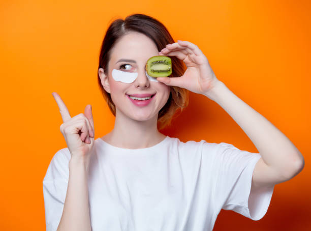 istock Woman using eye patch for her eyes and holding kiwi 849927838
