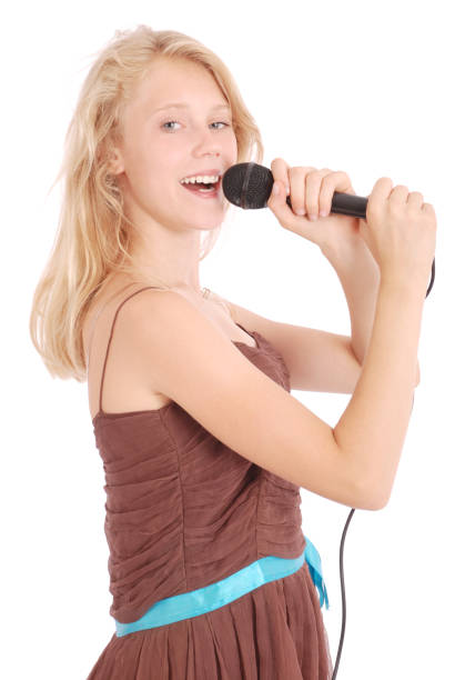 istock Happy young beautiful girl singing with microphone 849931026