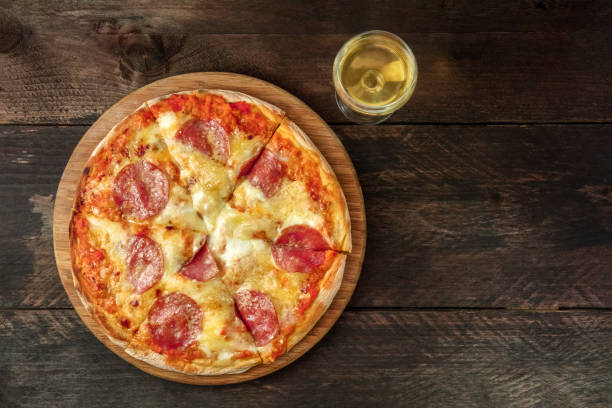 istock Pepperoni pizza with white wine, and place for text 849932016