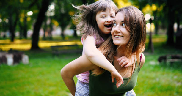 istock Little girl with special needs enjoy spending time with mother 849934546