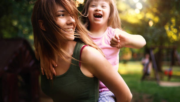 istock Little girl with special needs enjoy spending time with mother 849934586