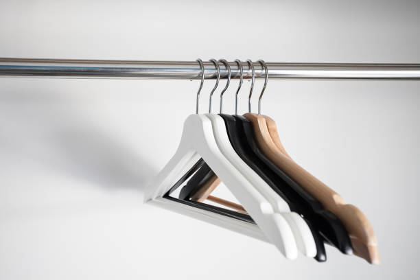 istock Wooden hangers on white wall background 849938216