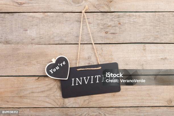 Blackboards With Text Youre Invited On Wooden Background Stock Photo - Download Image Now