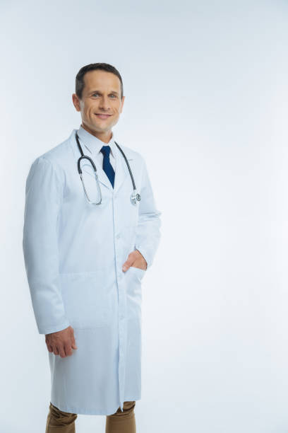 istock Positive minded mature doctor posing with hand in pocket 849957330