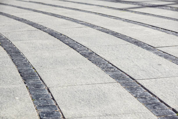 istock Stone pavement texture. Granite cobble stoned pavement background. Abstract background of old cobblestone pavement 849970548