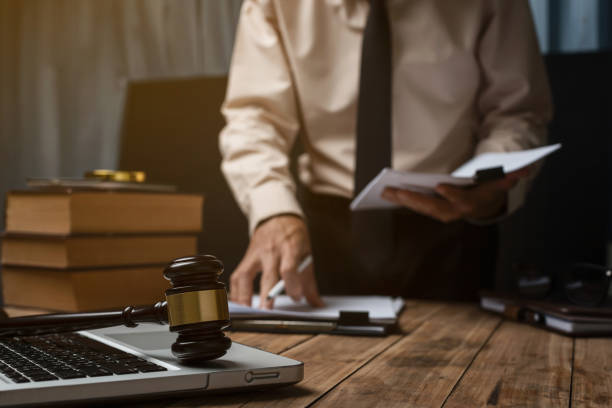 istock Business lawyer working hard at office desk workplace with book and documents. 849970610
