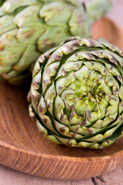 istock artichokes on old wooden surface 850003192