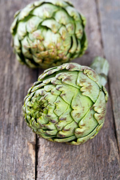 istock artichokes on old wooden surface 850003196