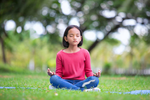 asian girl doing yoga pose in the park outdoor asian girl doing yoga pose in the park outdoor mindfulness children stock pictures, royalty-free photos & images