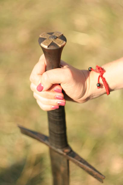 istock Woman hand holds sword. 850029584