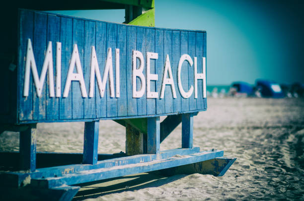 Classic wooden lifeguard hut standing under bright tropical sunlight on South Beach in Miami, Florida
