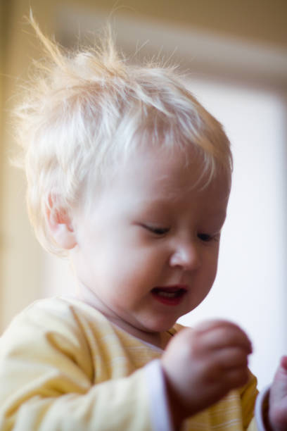 istock blond child looks closely 850091618