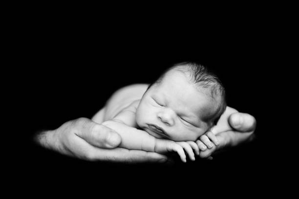 istock Beautiful baby boy, sleeping peacefully in fathers hands, infant sleeping 850109516