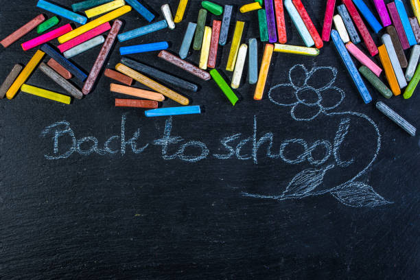 istock Black Chalkboard with back to school text written with white chalk on blackboard, start of education after summer holidays 850120482