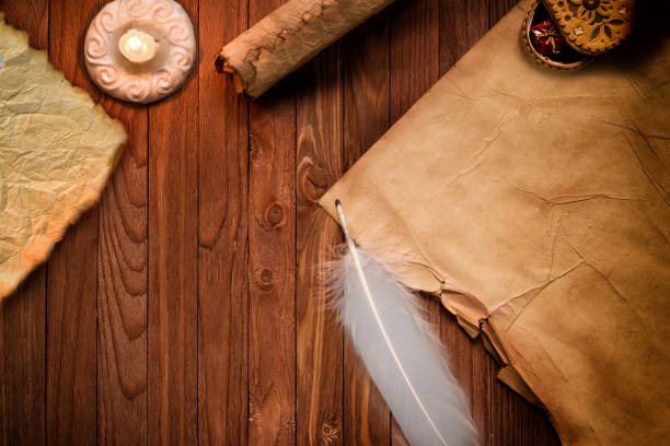 istock Old blank antique scroll paper on table with quill pen and candle 850121534
