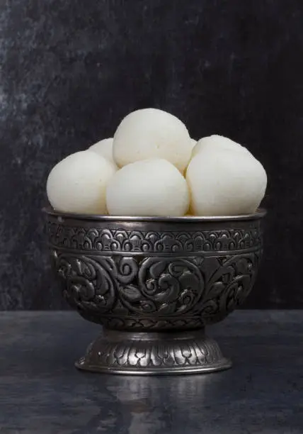 Rasgulla is a syrupy dessert popular in the Indian Festivals and It is made from ball shaped dumplings of chhena and semolina dough, cooked in light syrup made of sugar