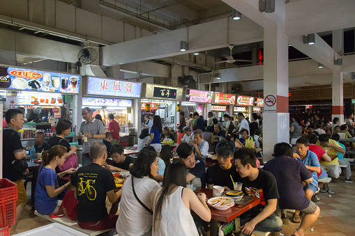 Singapore, Singapore - January 31, 2015: People enjoying food at the Lau Pa Sat foodcourt .
