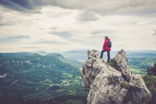 Senior woman in the mountains looking at the view, Slovenia, Europe. All logos removed. NIKON D3X, 24.0-70.0 mm f/2.8.