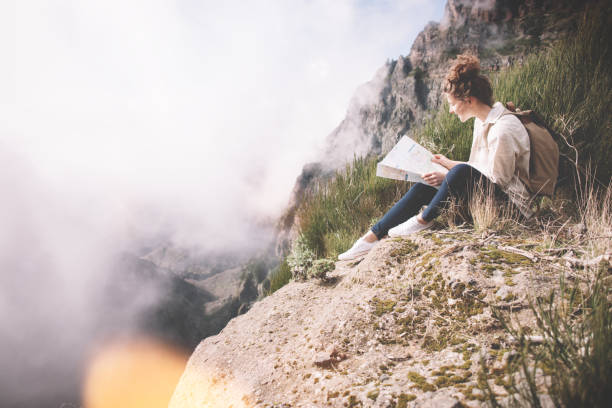 istock Woman sitting with map in the wild 850129820