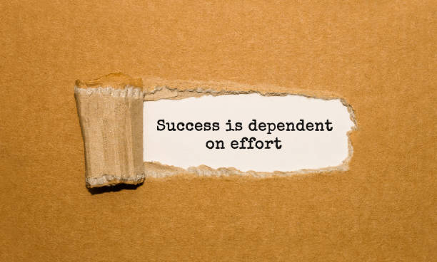 istock The text Success is dependent on effort appearing behind torn brown paper 850141200