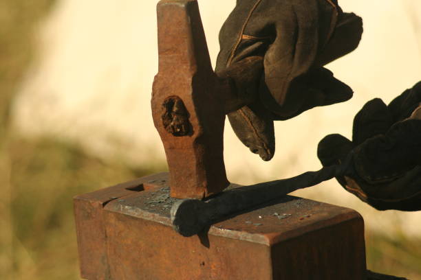 istock Blacksmith working process. Close-up of anvil and blacksmith hand holding hummer 850141340