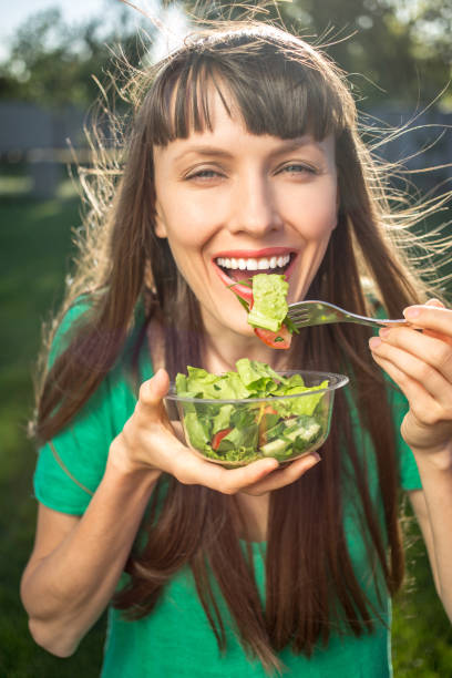 istock Woman eating healthy salad 850141436