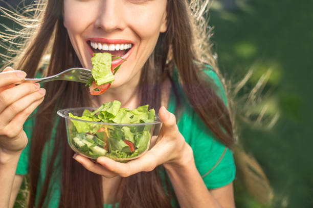 istock Woman eating healthy salad 850141840