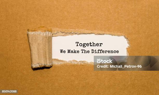 The Text Together We Make The Difference Appearing Behind Torn Brown Paper Stock Photo - Download Image Now