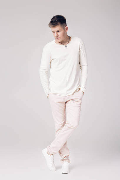 istock handsome young man in a white sweater and pants 850175822