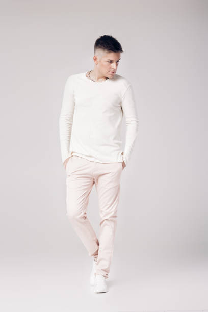 istock handsome young man in a white sweater and pants 850175942