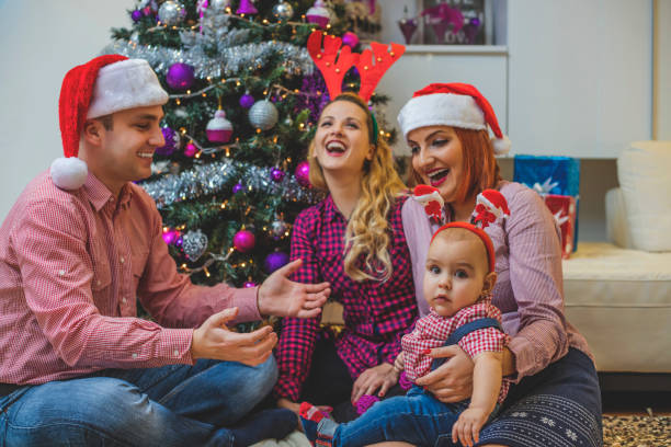istock Happy family in front of Christmas tree 850179478