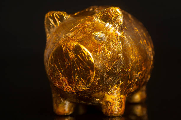 istock Golden piggy bank on black background 850179802