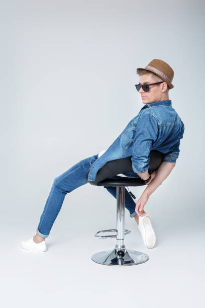 istock handsome man in denim sits on chair 850182768