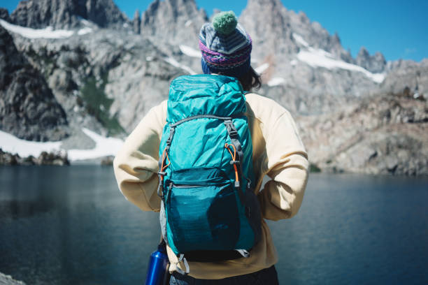 istock Young woman hipster hiking in wilderness with backpack 850186352