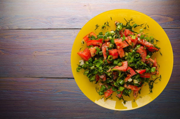 istock tomatoes, onion, fennel on a plate on a wooden background 850186706
