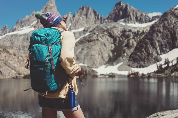 istock Young woman hipster hiking in wilderness with backpack 850187204