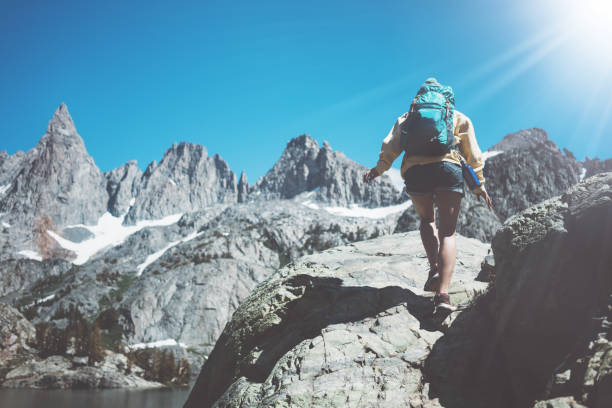 istock Young woman hipster hiking in wilderness with backpack 850190284
