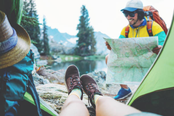 Couple of backpackers hiking and camping in wild stock photo