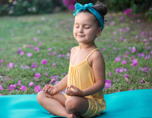 istock Little girl meditating 850194454
