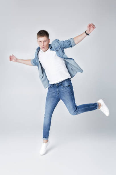 istock handsome man in jeans and jacket jumping 850196042