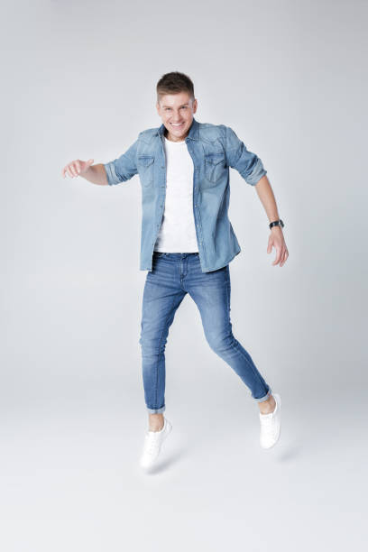 istock handsome man in jeans and jacket jumping 850196220