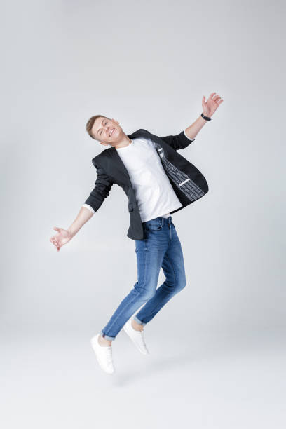 istock handsome man in jeans and jacket jumping 850196372